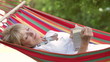 Video: Senior Woman Relaxing In Hammock With Book Senior Woman Relaxing In Hammock With Book