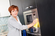 Woman cleaning kitchen