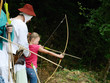 Girl with a bow at the festival of historical reenactment