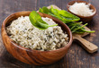 Risotto with spinach in wooden bowl