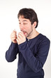 Man with cold holding tissue