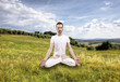 young man practicing yoga outdoor, lotus poition