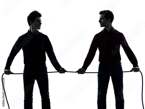 Photo: two men twin brother friends tug of war silhouette two men twin brother friends tug of war silhouette