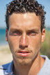 Portrait of a handsome young mediterranean man with curly hair