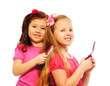 Two girls brushing hair