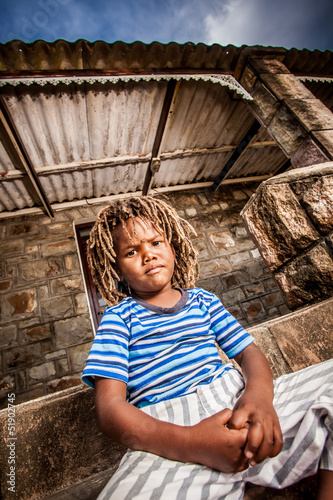 Photo: Rasta little boy sulking on the porch Rasta little boy sulking on the porch