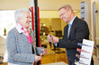 Optician helping senior woman