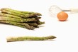 Asparagus and egg on white background