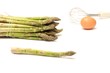 Asparagus and egg on white background