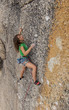 Female climber gripping the rock.