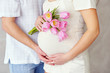Pregnant woman belly with tulips