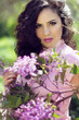 Young brunette woman with lilac flowers, Outdoors portrait