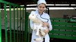 veterinarian holding a lamb on the farm