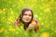 woman blow on dandelion