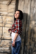 pretty young girl in front of old house