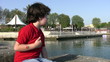 Little boy throwing stones into the sea