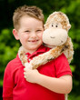 Photo: Portrait of boy playing with his stuffed animal pet Portrait of boy playing with his stuffed animal pet