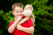 Photo: Portrait of boy playing with his stuffed animal pet Portrait of boy playing with his stuffed animal pet