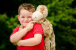 Photo: Portrait of boy playing with his stuffed animal pet Portrait of boy playing with his stuffed animal pet