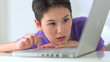 Mixed race Asian woman using laptop computer