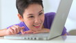 Mixed race Asian woman using laptop computer