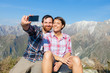 Couple Taking Self Portrait at Top of Mountain