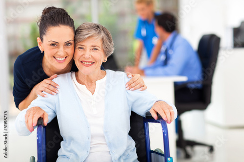 Photo: adult daughter accompanying senior mother visiting doctor adult daughter accompanying senior mother visiting doctor