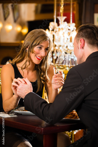 Photo: happy couple have a romantic date in restaurant happy couple have a romantic date in restaurant