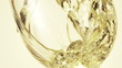 Close-up shot of wine pouring wine in glass against white backgr