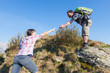 Man Helping His Girlfriend Hiking