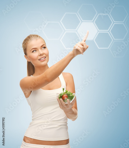 Photo: woman with salad and virtual screen woman with salad and virtual screen