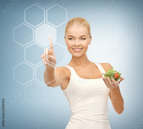 Photo: woman with salad and virtual screen woman with salad and virtual screen