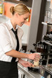 Photo: Attractive waitress making coffee with machine Attractive waitress making coffee with machine