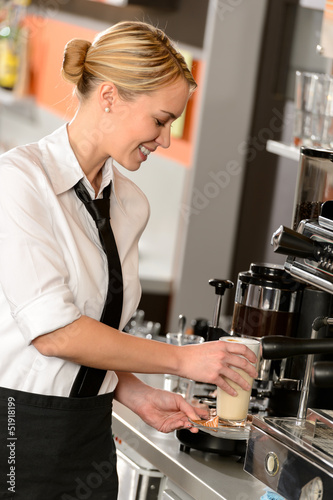 Photo: Attractive waitress making coffee with machine Attractive waitress making coffee with machine