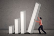 Photo: Asian businessman pushing a bar chart Asian businessman pushing a bar chart