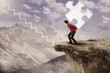 Photo: Businessman walk up with puzzle on mountain Businessman walk up with puzzle on mountain