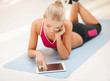 woman lying on the floor with tablet pc