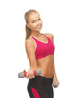 young sporty woman with light dumbbells