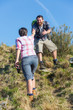 Man Helping His Girlfriend Hiking