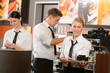 Photo: Confident waitresses and waiter working in bar Confident waitresses and waiter working in bar