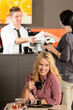 Photo: Happy female customer drinking espresso in cafe Happy female customer drinking espresso in cafe