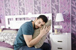 Tired man in bedroom.