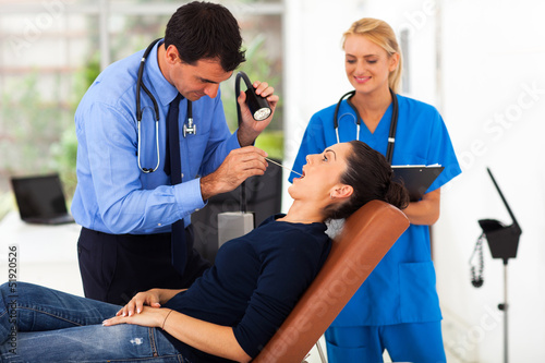 Photo: woman having throat examination woman having throat examination