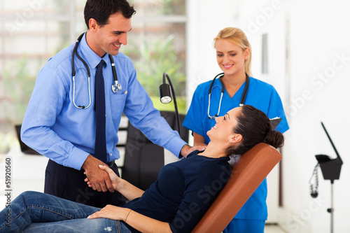 Photo: doctor congratulating female patient for her successful recovery doctor congratulating female patient for her successful recovery