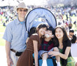 Large multiracial family in crowd with disabled child in wheelch