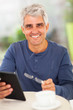 happy middle aged man with tablet computer