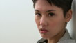 Serious young Asian young woman looking at camera