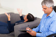 Photo: middle aged therapist consulting patient middle aged therapist consulting patient