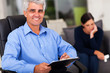 Photo: middle aged male psychologist in office middle aged male psychologist in office