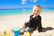 Photo: Little Boy Playing in the Sand on Beach Little Boy Playing in the Sand on Beach